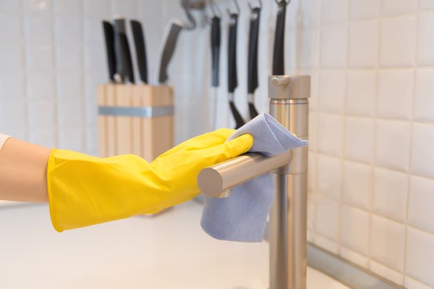closeup-female-hand-gloves-cleaning-kitchen-tap